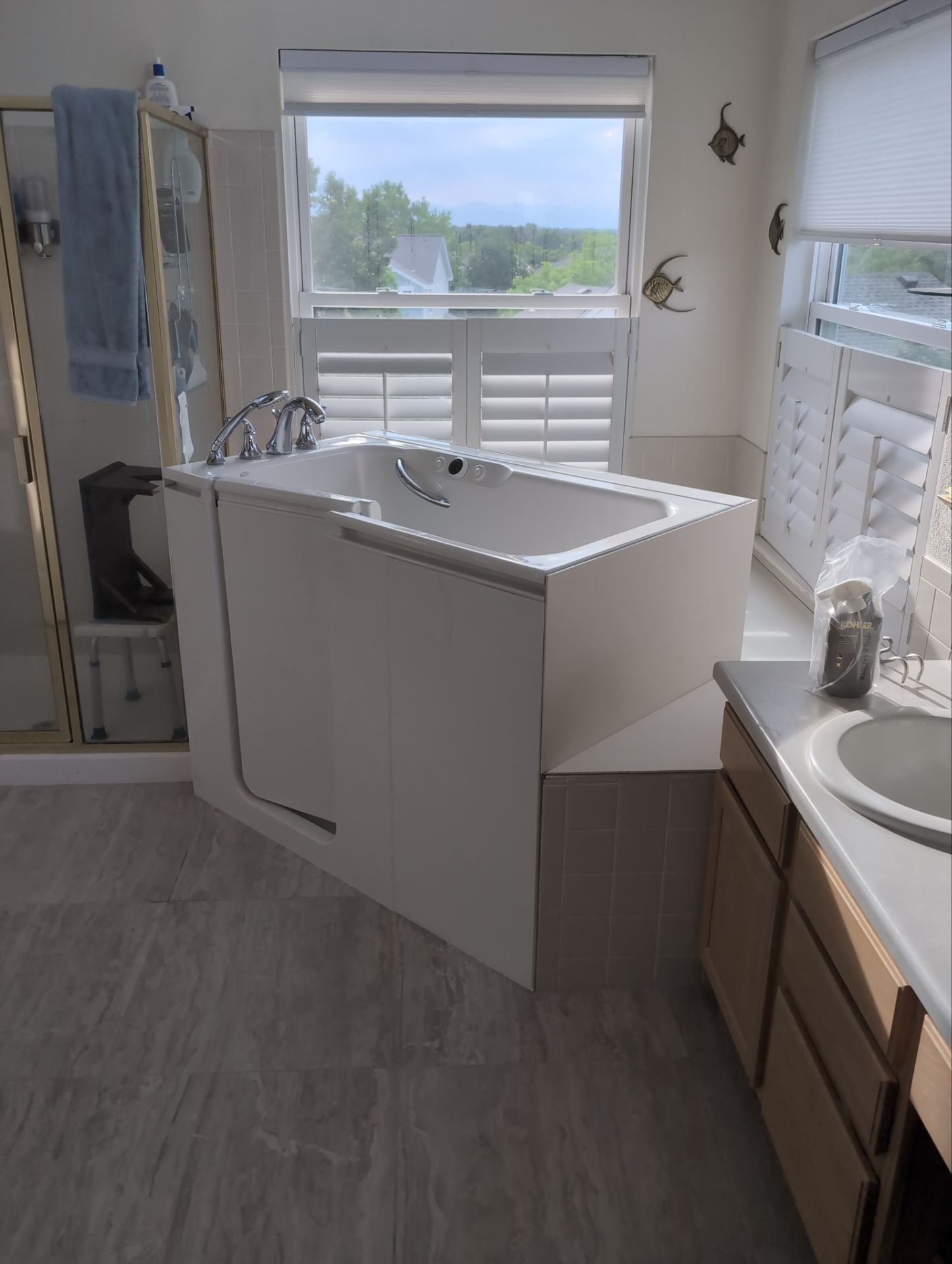 Walk-in tub installation in Aurora, Colorado bathroom remodel with safety door and chrome fixtures
